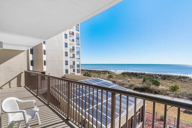 balcony featuring a beach view and a water view