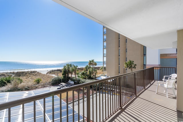 balcony with a water view and a beach view