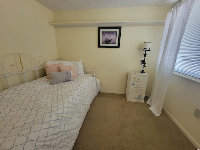 carpeted bedroom featuring baseboards