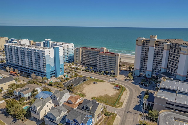 drone / aerial view featuring a view of city and a water view