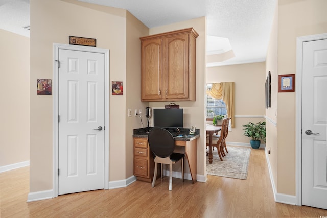 office area with baseboards and light wood-style floors