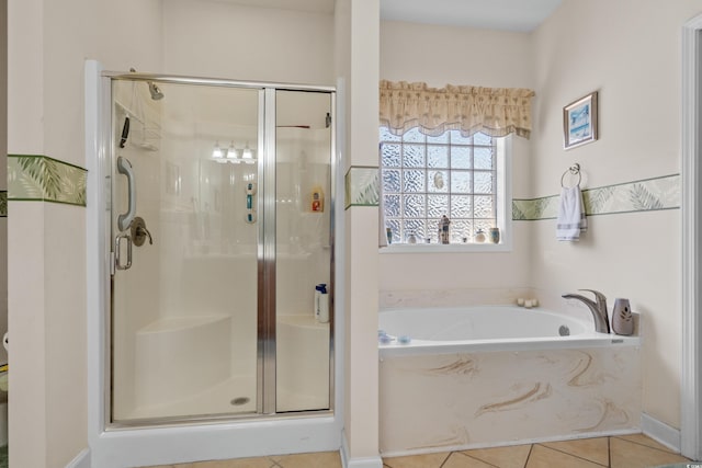 bathroom with a garden tub, a stall shower, and tile patterned floors