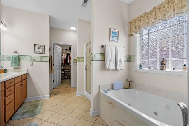 full bath featuring vanity, visible vents, a stall shower, tile patterned flooring, and a spacious closet