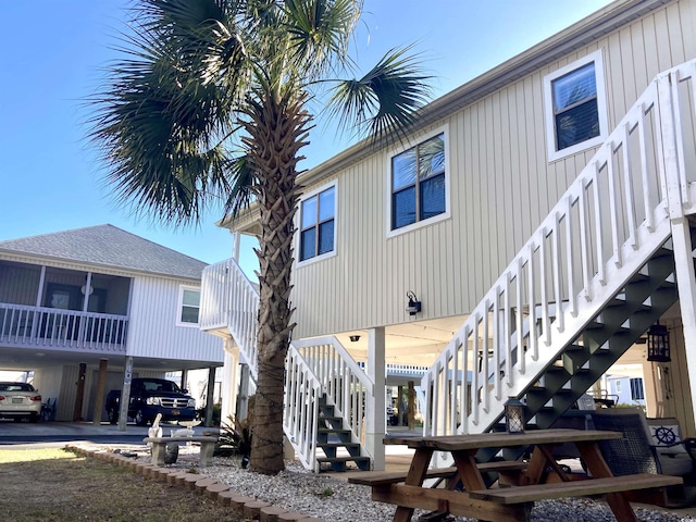 exterior space featuring a carport and stairway