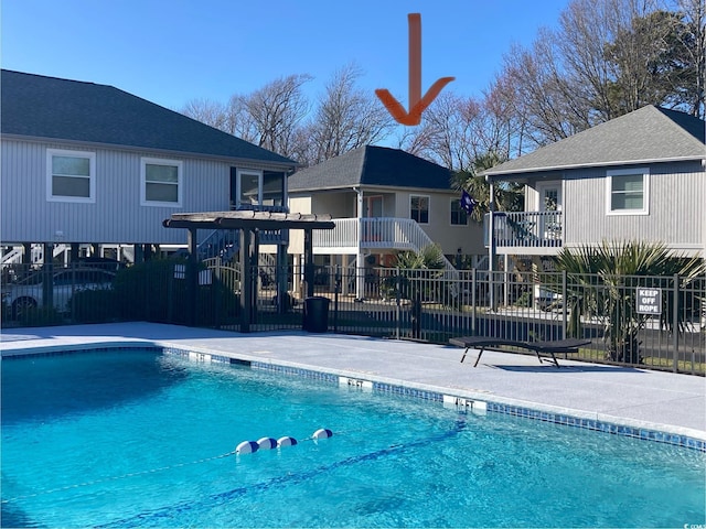 pool featuring a patio area and fence