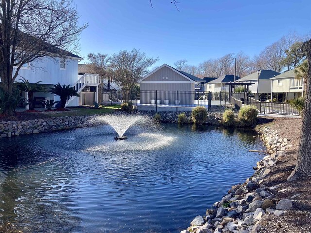 water view with fence and a residential view