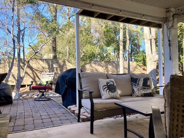 view of patio / terrace featuring outdoor lounge area and fence