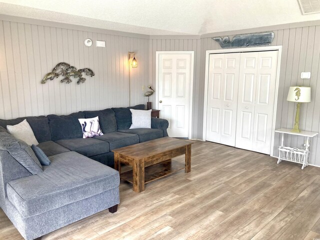 living room with light wood-type flooring and visible vents