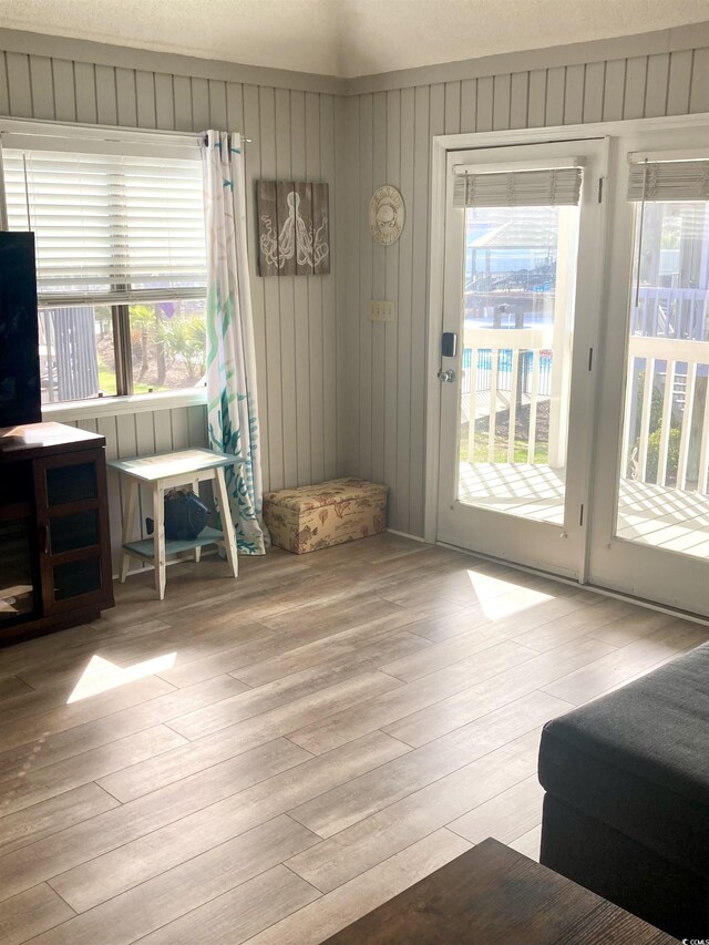 entryway with plenty of natural light and wood finished floors