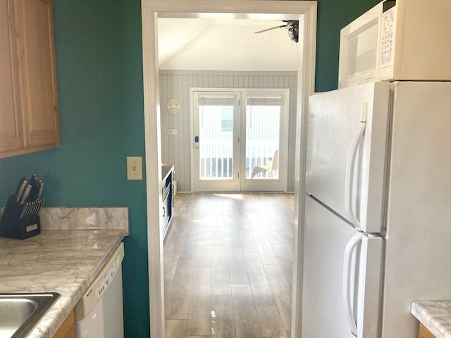 kitchen with white appliances, light wood-style flooring, a sink, ceiling fan, and light countertops