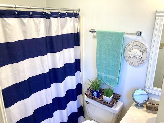 bathroom featuring toilet and a shower with shower curtain