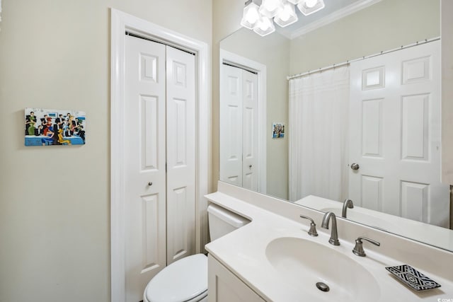 full bath featuring a closet, toilet, vanity, and crown molding