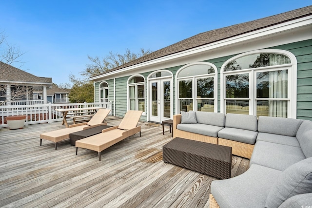 wooden deck with french doors and an outdoor hangout area