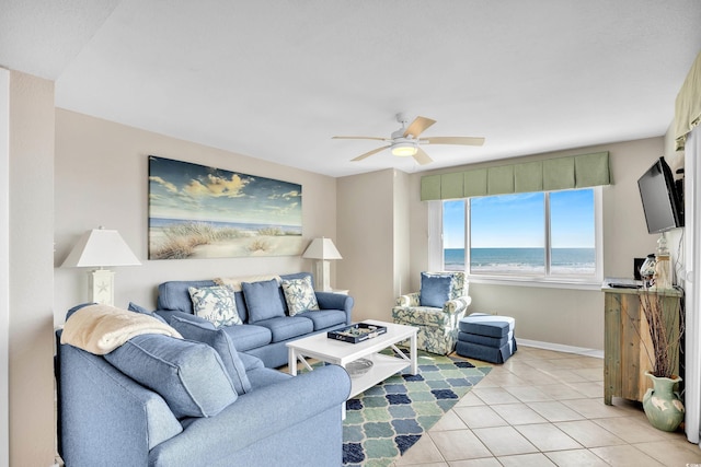 living room with light tile patterned flooring, a ceiling fan, and baseboards