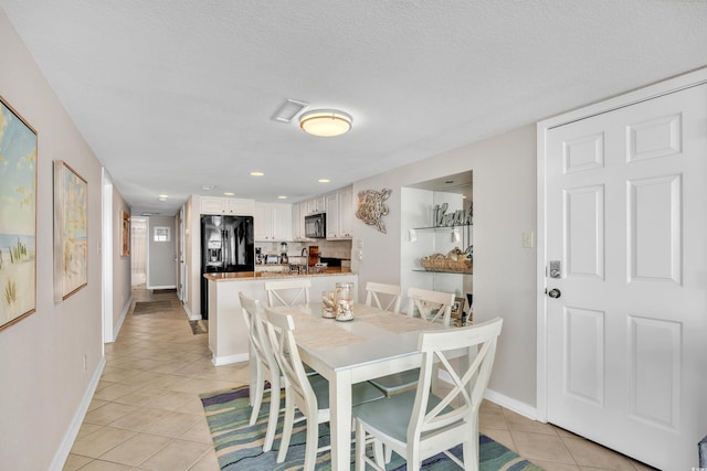 dining area featuring visible vents, a textured ceiling, recessed lighting, light tile patterned floors, and baseboards