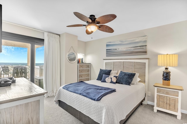 bedroom featuring access to exterior, light colored carpet, baseboards, and ceiling fan