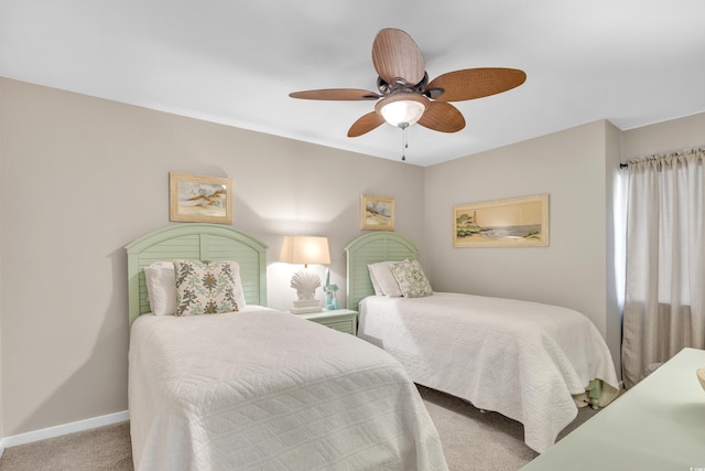 carpeted bedroom featuring a ceiling fan and baseboards