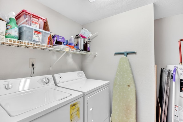 laundry room with laundry area, a textured ceiling, electric water heater, and separate washer and dryer