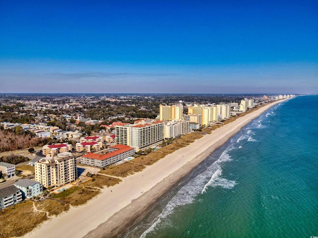 bird's eye view featuring a water view, a city view, and a beach view