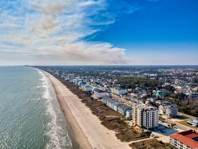 birds eye view of property with a water view, a city view, and a beach view