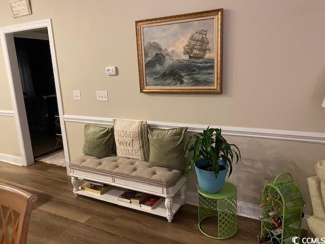 sitting room featuring baseboards and wood finished floors