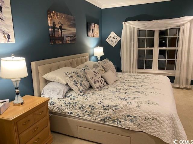 bedroom featuring carpet flooring and ornamental molding