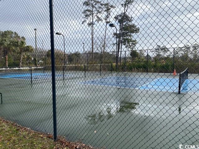 view of sport court with fence