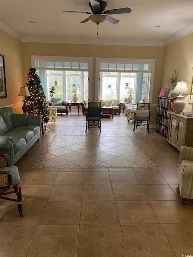 living area featuring tile patterned floors, a healthy amount of sunlight, and crown molding