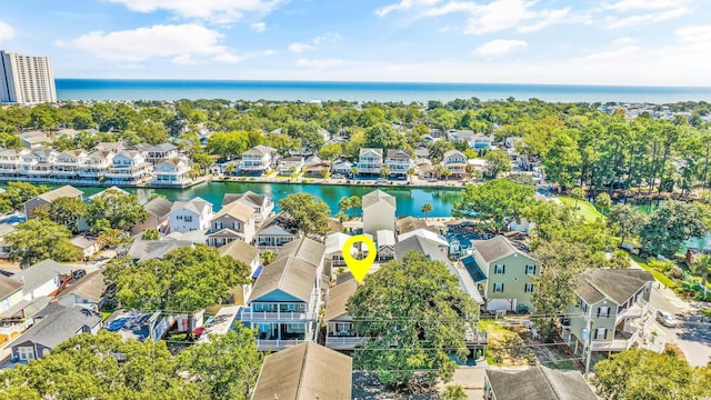 drone / aerial view with a water view and a residential view