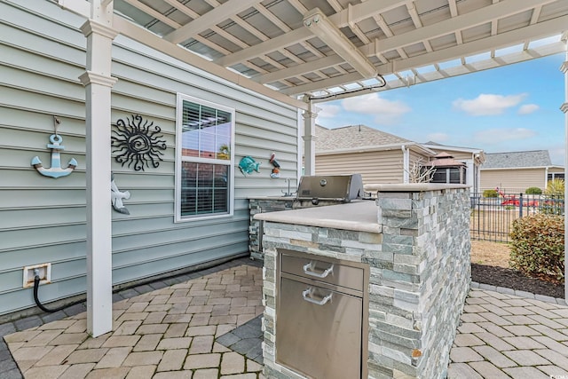 view of patio featuring area for grilling and fence