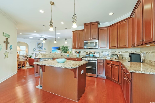 kitchen with stainless steel appliances, arched walkways, crown molding, decorative backsplash, and light stone countertops