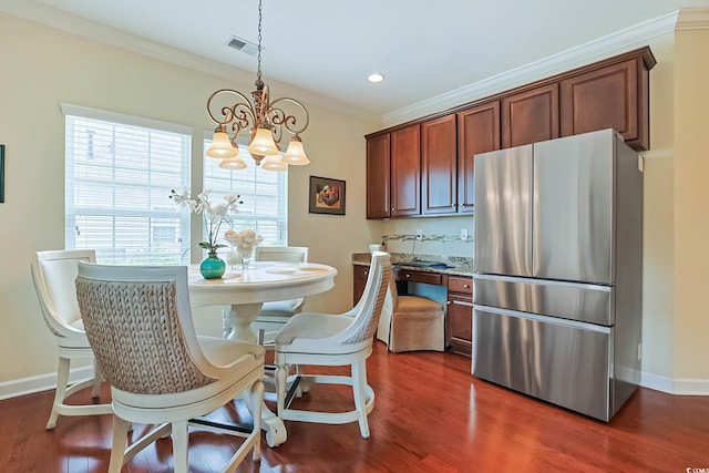 dining area with dark wood finished floors, visible vents, a chandelier, and crown molding