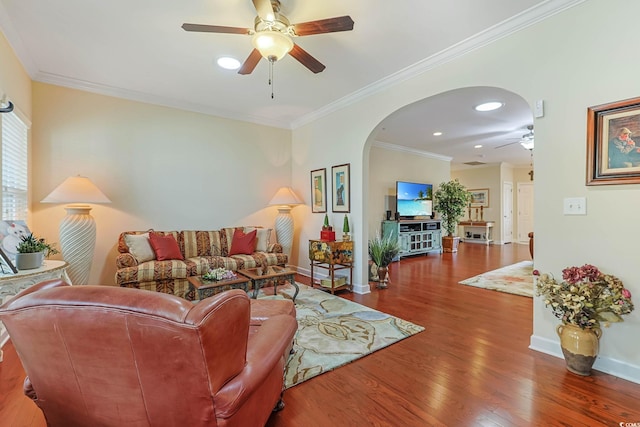 living room with baseboards, arched walkways, wood finished floors, and ornamental molding