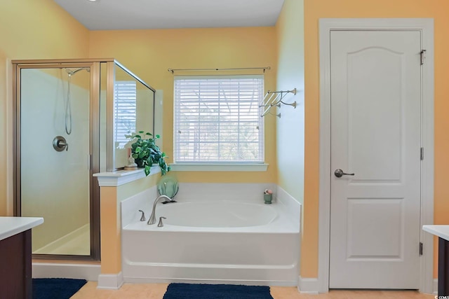 bathroom featuring a stall shower, vanity, and a bath