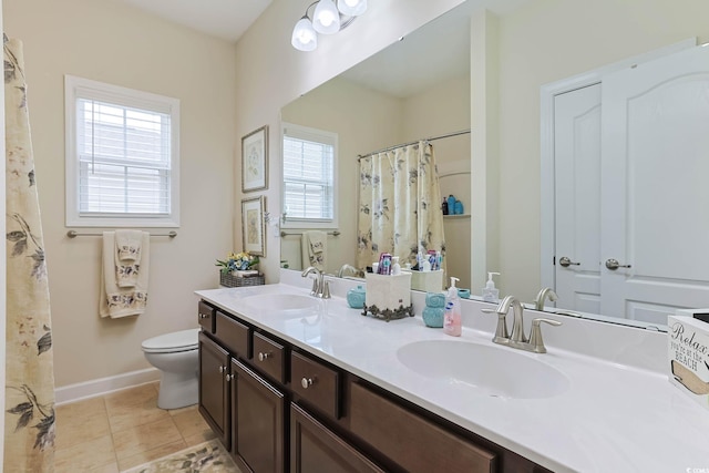 full bath with a sink, baseboards, toilet, and tile patterned floors