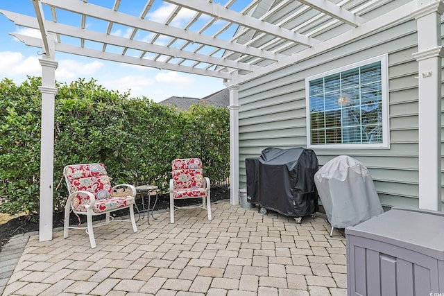 view of patio featuring a grill and a pergola