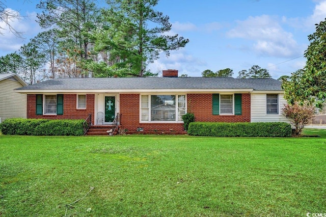 single story home with a front yard, brick siding, and a chimney