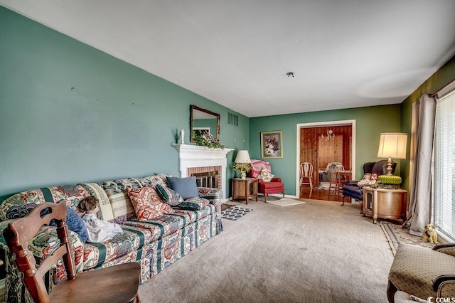 living room featuring a fireplace, carpet, and visible vents