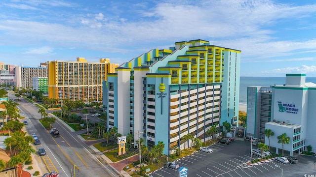 view of building exterior with a city view and uncovered parking