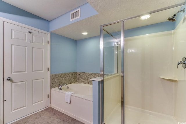 full bathroom with visible vents, a bath, a shower stall, and tile patterned flooring