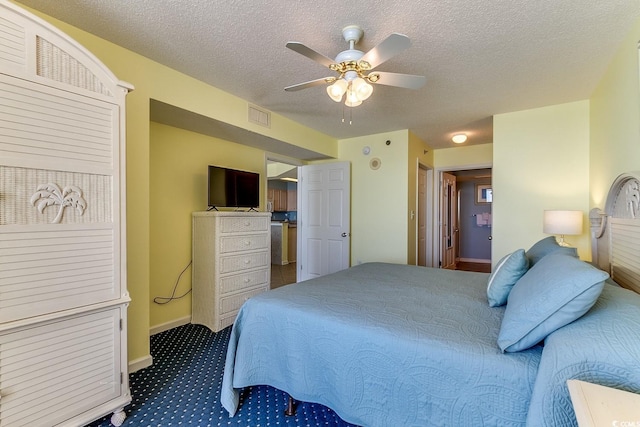 bedroom featuring visible vents, a textured ceiling, carpet floors, baseboards, and ceiling fan