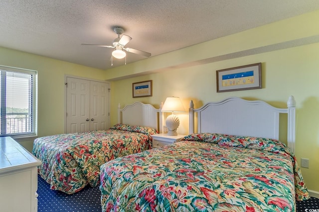 bedroom with a closet, a textured ceiling, a ceiling fan, and carpet