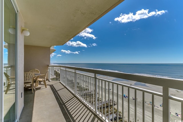 balcony with a beach view and a water view