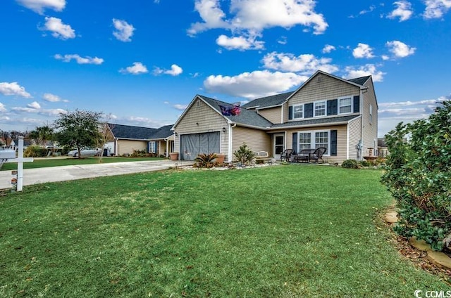 traditional-style home featuring concrete driveway, a garage, and a front yard