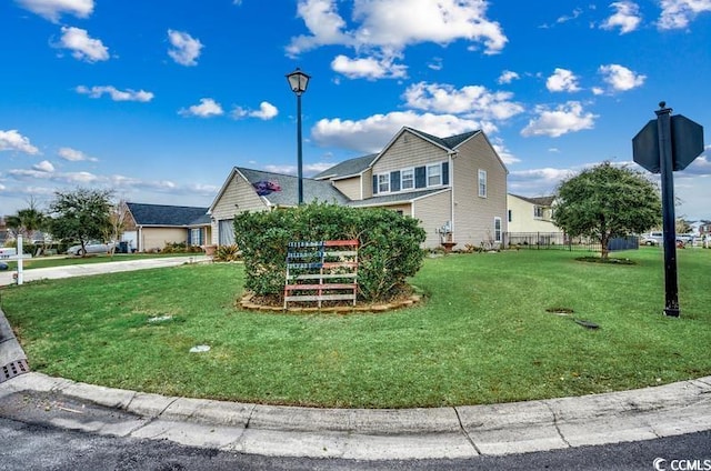 view of front of home with driveway and a front lawn