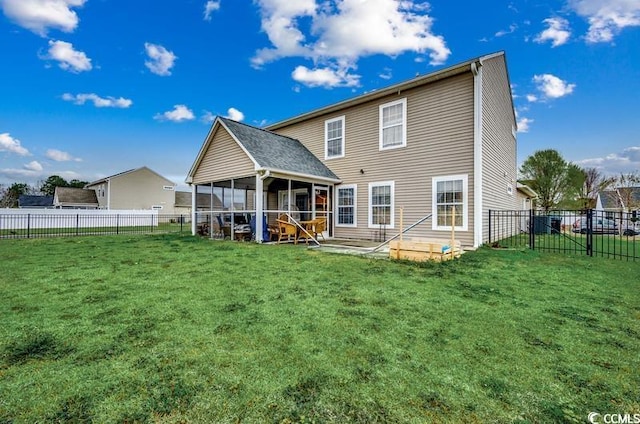 back of house featuring a yard, a fenced backyard, and a sunroom