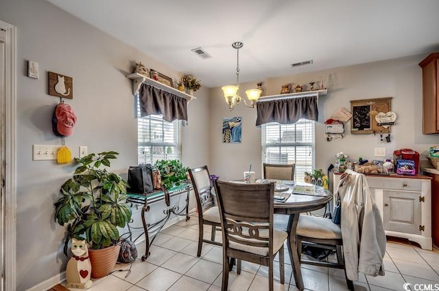 dining area featuring a notable chandelier, visible vents, and a wealth of natural light