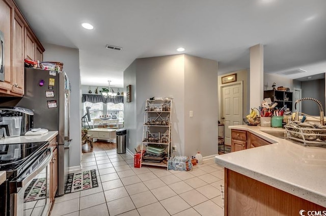 kitchen with visible vents, electric range, light tile patterned flooring, a sink, and light countertops