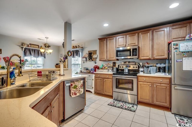 kitchen with a sink, light countertops, and stainless steel appliances