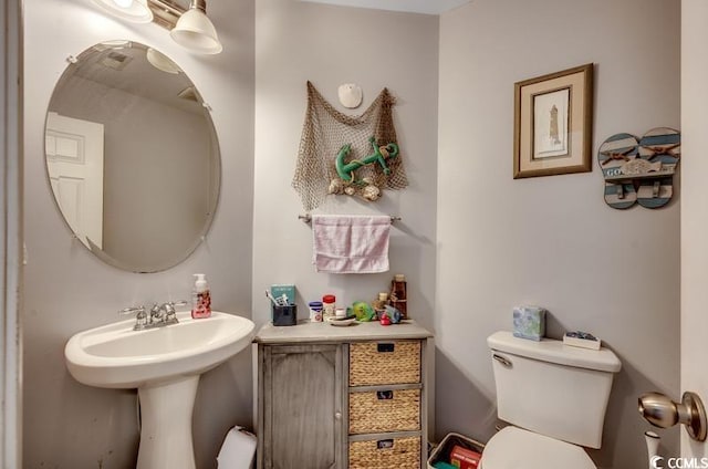 bathroom with toilet and a sink